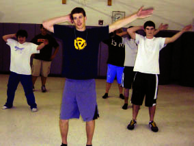 Boys dance team practices for performance