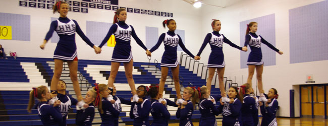 The competition cheerleading team performs during a pep rally.