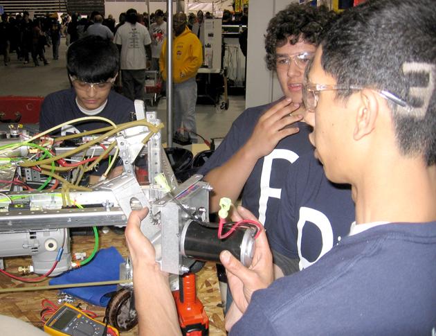Members of the Robotics Club make quick changes to their project.