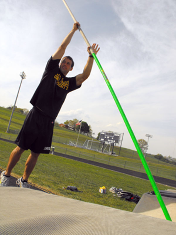 HHS alum Tim Bierle shows the correct pole vaulting technique during practice. Photo by Maria Rose