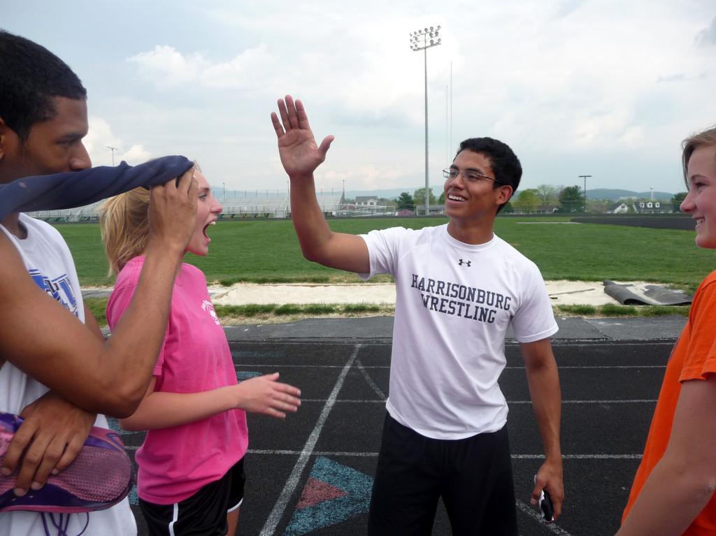 HHS alum Tony Villeda give runners encouragement during practice. Villeda has returned to coach during the 2010 outdoor season. Photo by Vanessa Ehrenpreis