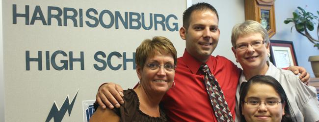 Former assistant principal Jeremy Knapp poses with the attendance secretaries on his last day of school. Photo by Maria Rose.