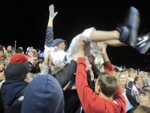 Junior Ben Harris is lifted above the Red Sea during a home football game. Photo by Molly Denman.
