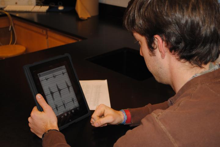 Teaching Assistant Ben Frederick uses his iPad in Mrs. Harris' Earth Science class. Photo by Jack Burden.