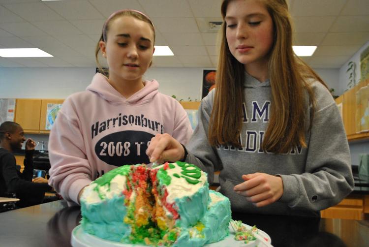 Freshmen Margaret Morrell and Hannah Purcell cut their cake. Photo by Paulina Rendon. 