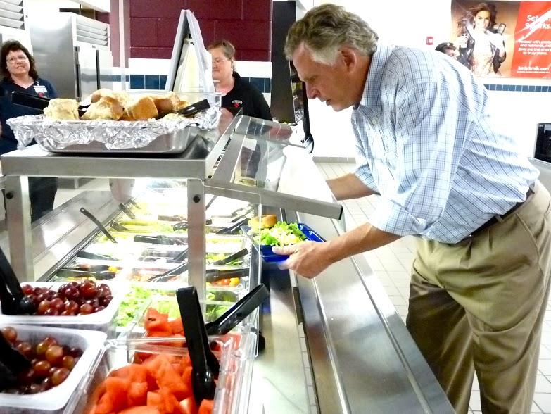 Governor McAuliffe fills his tray with Skyline Middle School lunch food.