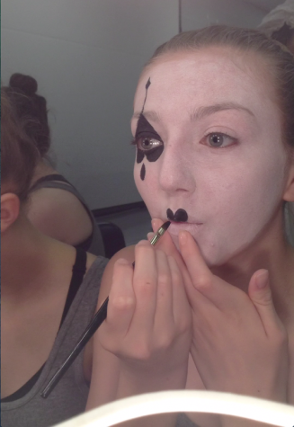 Noelle Warne prepares for the show by putting on mime make-up. 