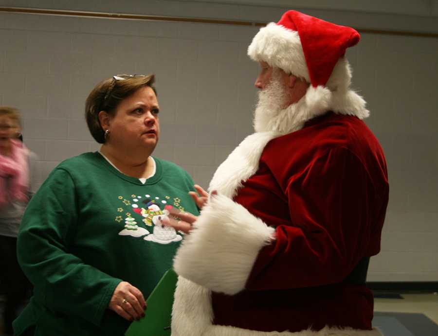 Principal Ms. Cynthia Prieto talking to Santa. 