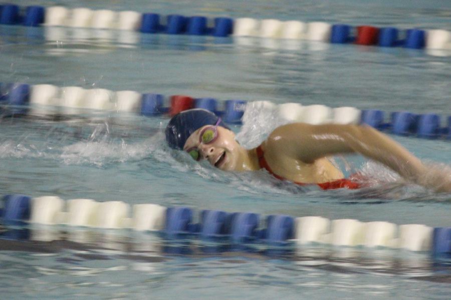 Freshman Jane Wyatt swimming freestyle.