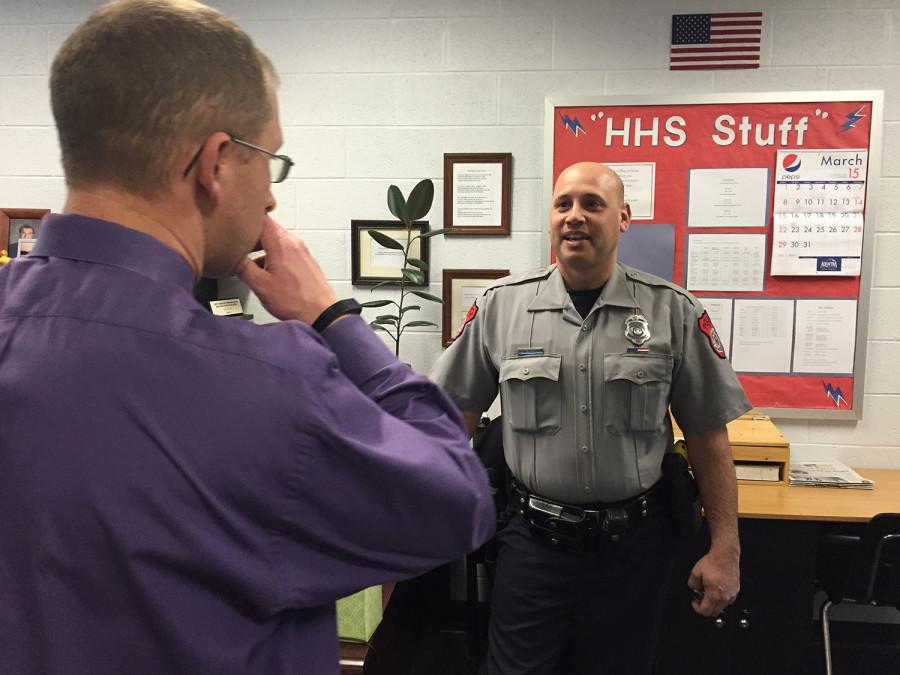 Officer Tim Carroll talking with Assistant Principal Eric Miller.