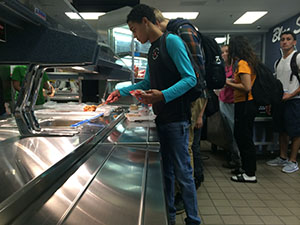 HHS students patiently wait in the busy lunch line eager to see whats for lunch.