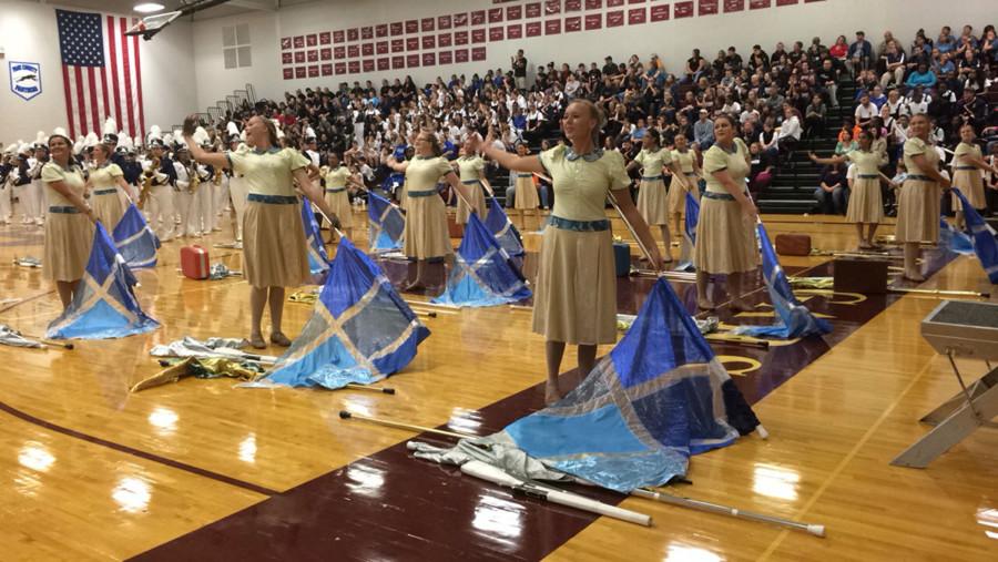Color gaurd member junior Kennedy Wolter (front) performs. 