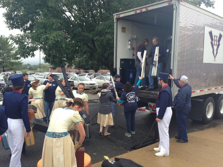 The band parents unload the truck for the upcoming performance. 