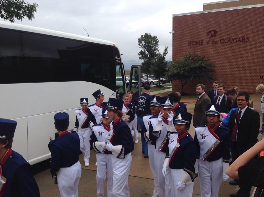 Members of the band come off of the bus.