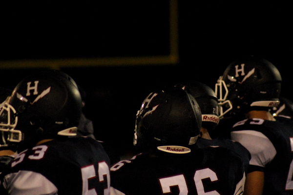 HHS players watch the game on the sidelines.