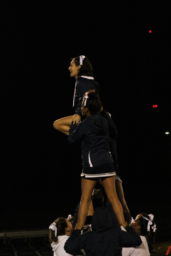 HHS sideline cheerleaders hold a pyramid as they cheer on the Streaks. 
