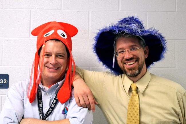 Math teachers Geoffray Estes and Brain Nussbaum pose together, wearing hats for spirit day on Monday. Spirit week will continue all throughout Homecoming celebration.