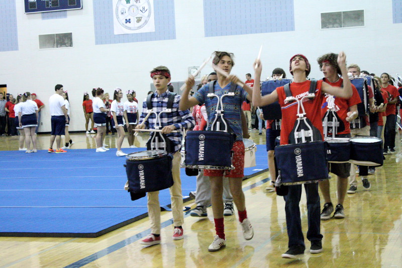 Drum line enters the gym to begin the pep rally.