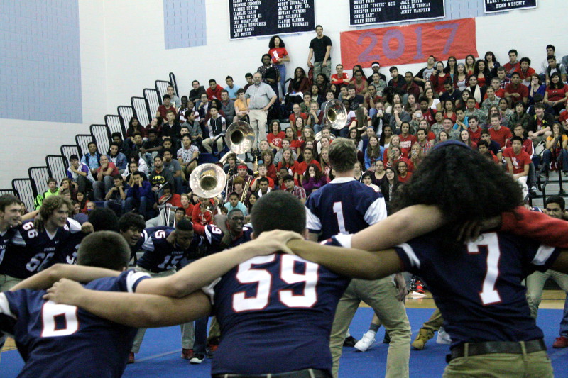 HHS Varsity Football team dances in celebration of Homecoming at the pep rally.