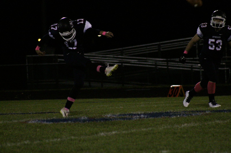 HHS player punts the ball.