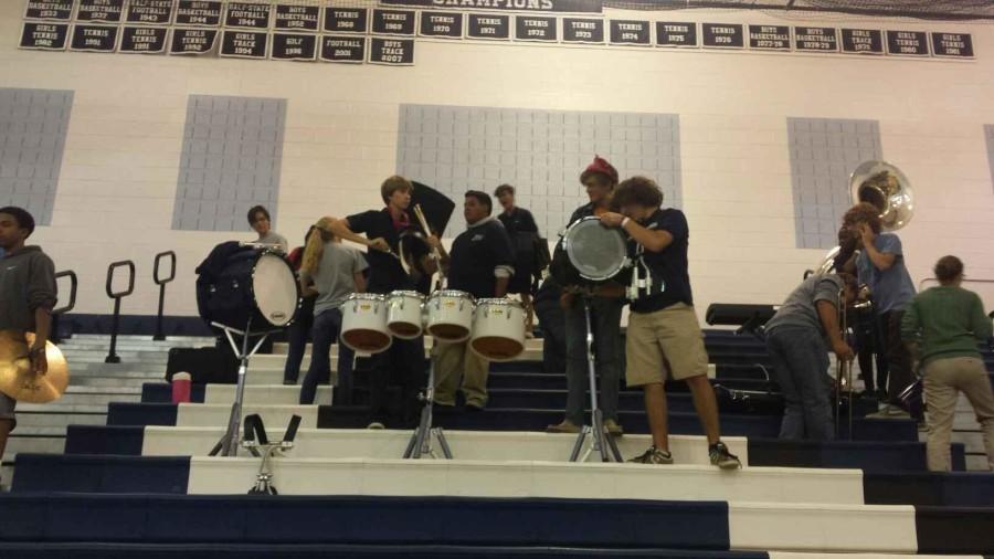 The pep band packs up after their performance. 