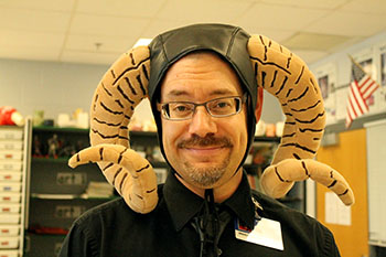 Librarian Bradley Walton poses wearing a bull themed hat. Hat Day is just one of the spirit days happening this week. 