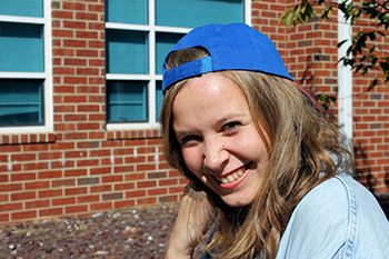 Junior Cecily Lawton poses adorned with a Mets themed hat. “The Mets are in the playoffs right now. I have a lot of home team pride because I’m from New York.” Lawton said.