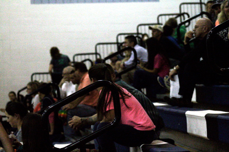 The audience waits in anticipation for a serve.
