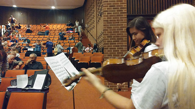 Collegiate School sophomore Georgia Vaughn and junior Jasmine Harper rehearse their prepared pieces while waiting for their audition. “[I auditioned today] because it’s required by my school, but I also really like playing the violin. [The most nerve-racking thing about the audition is] probably those people that always show off before we audition. I think just not being nervous is the most important part. Then you can be relaxed and play the best,” said Harper.