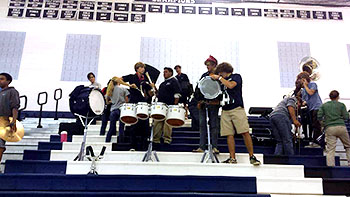 Pep band packs up after performing at the Broadway volleyball game.