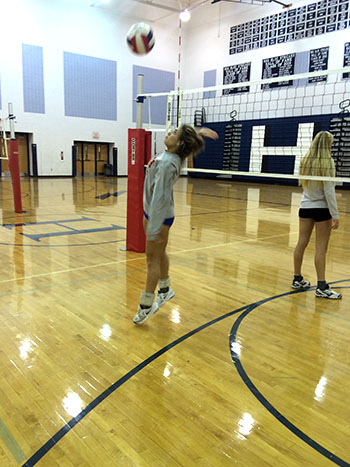 Senior Sophia Hartman hits at her pepper partner.