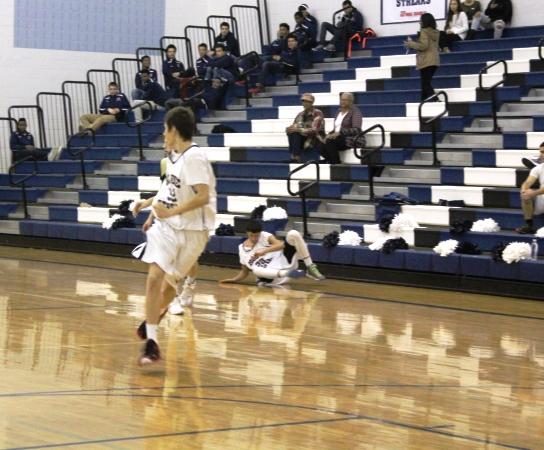 JV basketball player Freshman Josh Lichti runs across the court to catch up with the ball during the home game against James Wood high school.