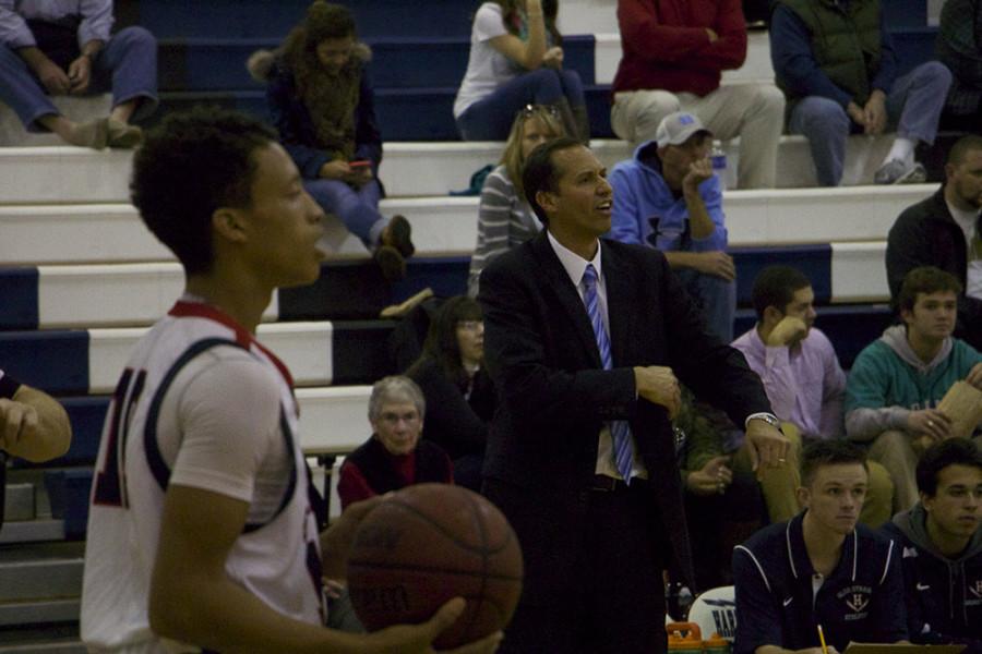 Coach Don Burgess gives instructions to his team as junior Kajuan Madden-McAfee preapres to inbound the ball. 