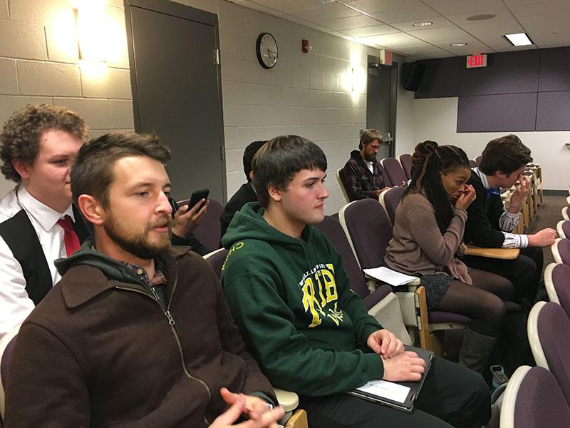 Debate teacher Aaron Cosner and alumni Evan Dotas wait for the awards. 