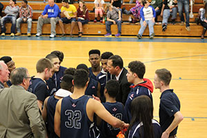 Coach Burgess talks with his players during a timeout. 