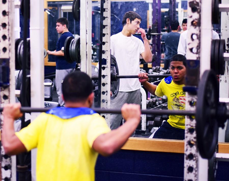 Freshman Edgar Alvira squatting in weight training class.