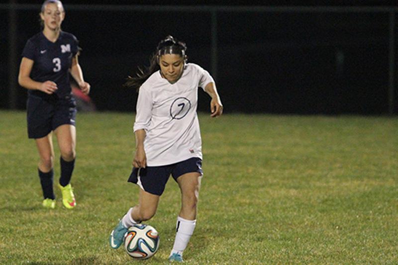 Karina Bautista takes the ball up the field.