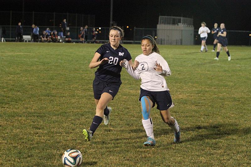 Alanna Macadam keeps leverage on the Millbrook defender to get the ball.