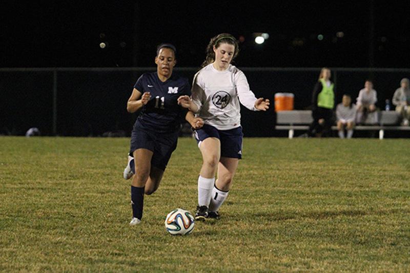 Audrey Knupp tries to take the ball away from the Millbrook player.