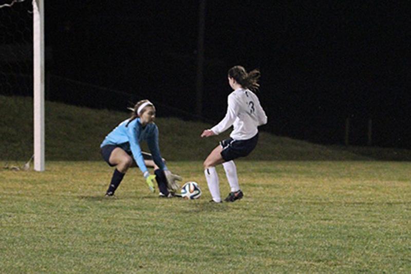 Faith Runnels attempts the get the ball past the goalie.