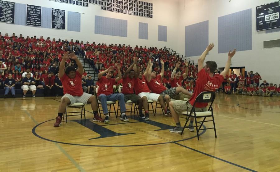 The upperclassmen show students at the Pep Rally how to properly do the rollercoaster cheer