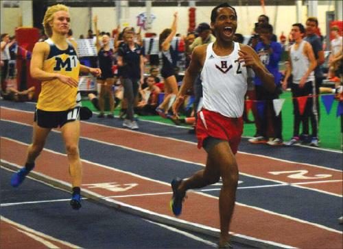 Alumnus Abrham Amine crosses the finish line in a pre-states meet last year during indoor track. 