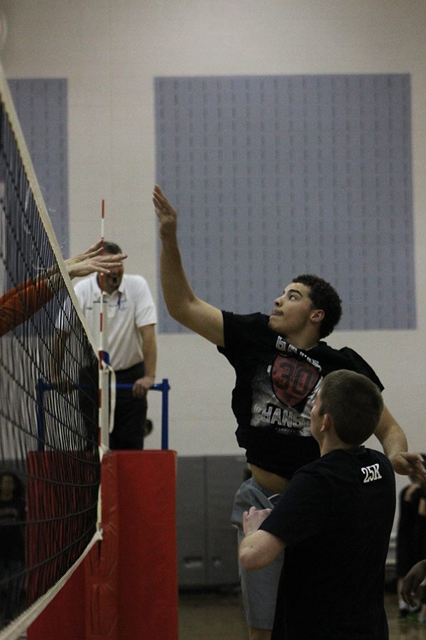 Junior Malachi Simmons prepares to spike the ball as it comes over the net.
