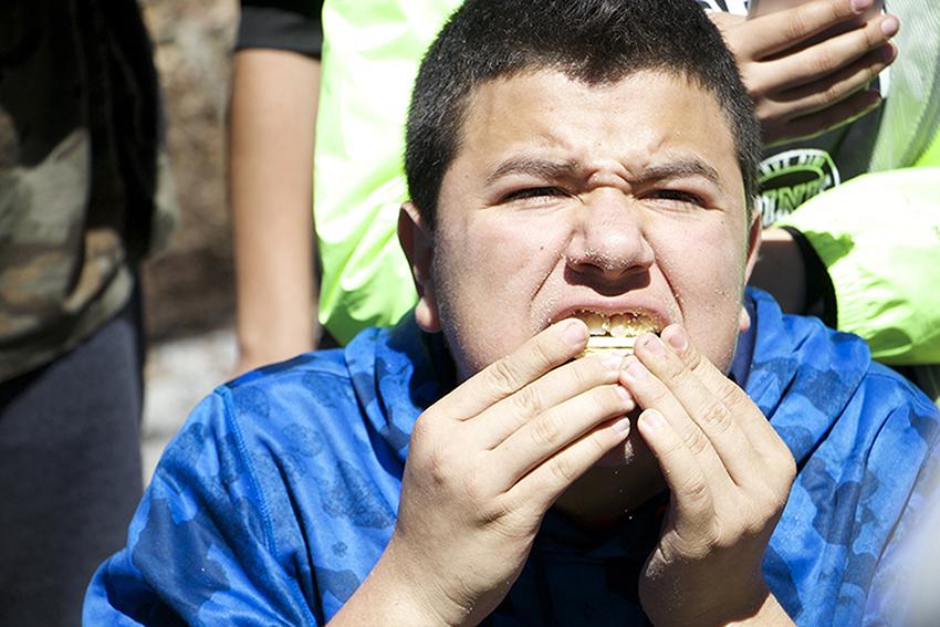 Kevin Aguilar, starts off strong during the cracker eating competition by attempting to stuff them all in his mouth at once