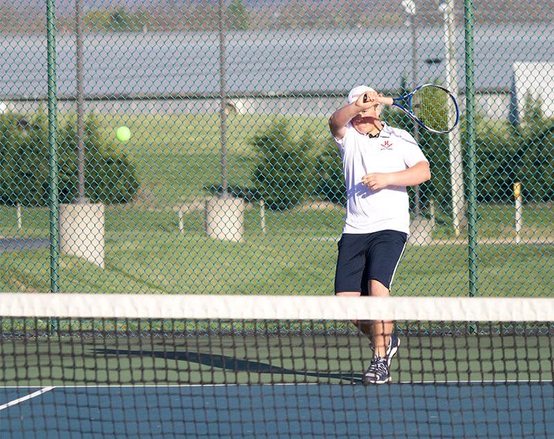 Alex Osinkosky volleys the ball in his doubles match with Tobias Yoder.