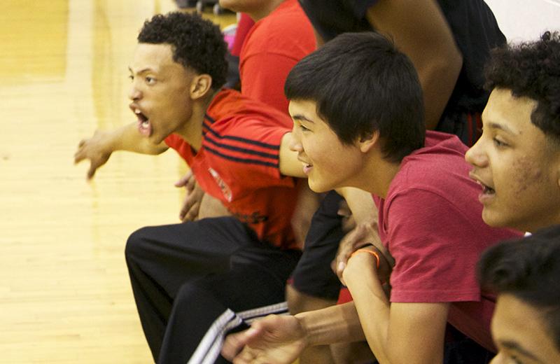 Member of the junior team react to the winning point scored for their volleyball team.