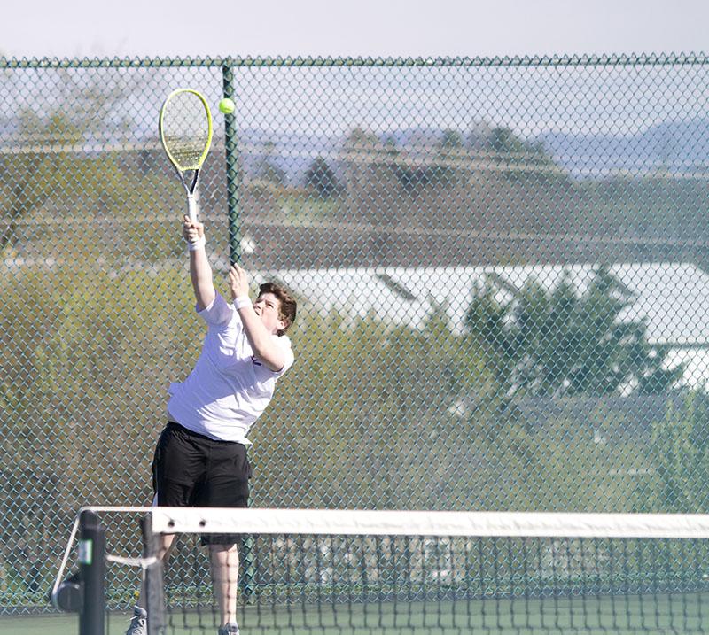 Tobias Yoder serves the ball in his singles match