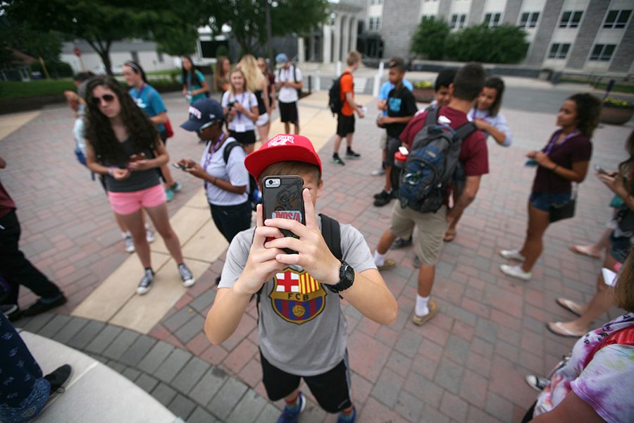 Using his Iphone, Mason Wyatt from Shelburne Middle School takes a photo during the campus tour.