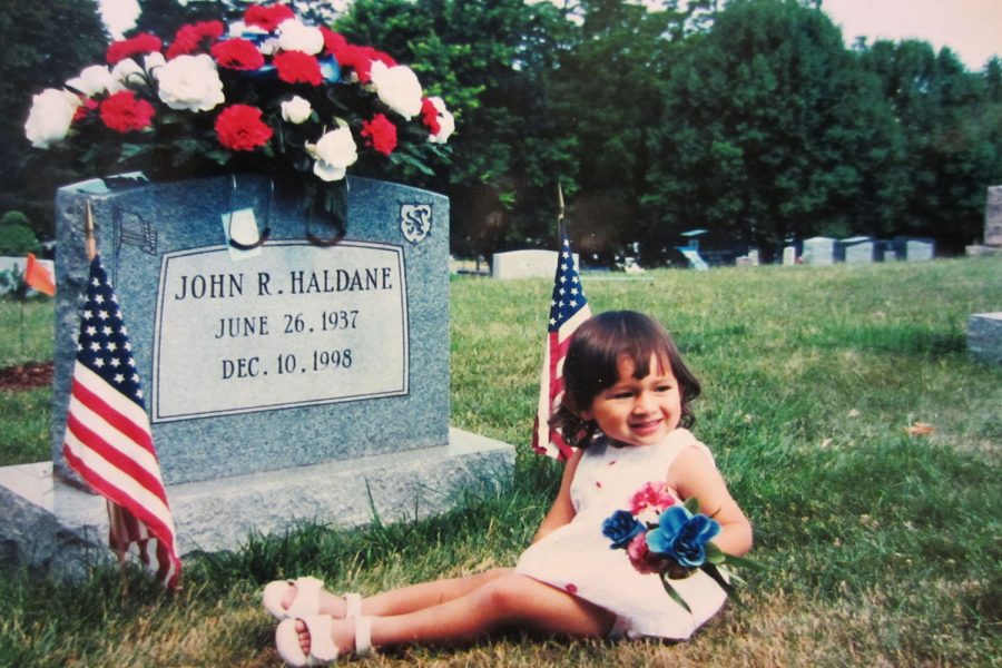 Doerr sits by her grandfathers grave as a young child