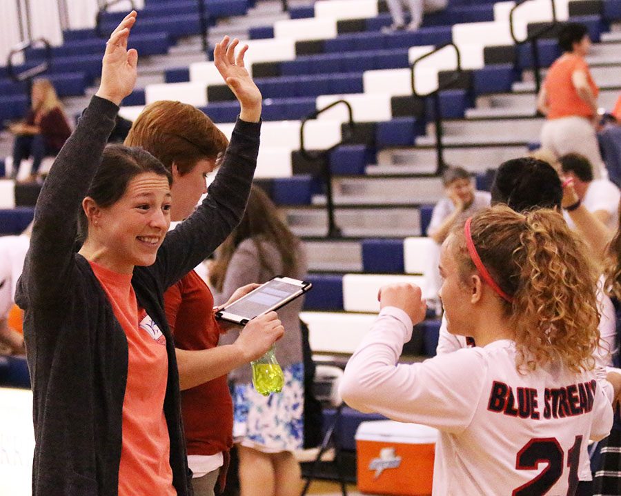 Varsity coach Hannah Bowman cheers on team captain Anne Penrod during a time out. 
